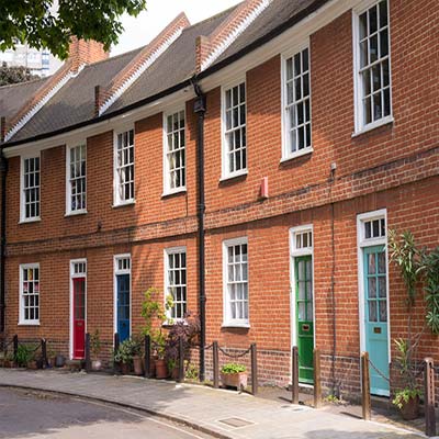 Victorian red bricked houses with coloured neat front doors