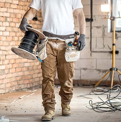 Electrical engineer holding a reel of cable