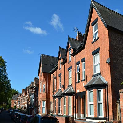 Narrow red bricked terraced houses with smart bay Windows