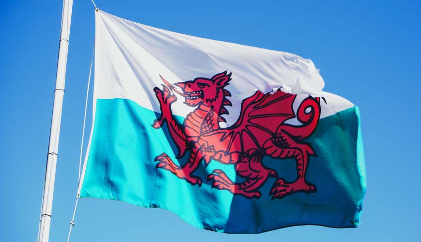 Welsh flag flying against bright blue sky