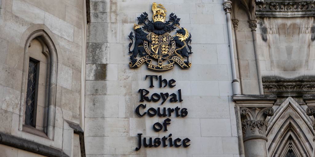 Royal Courts Of Justice sign and crest, on the side of the building itself