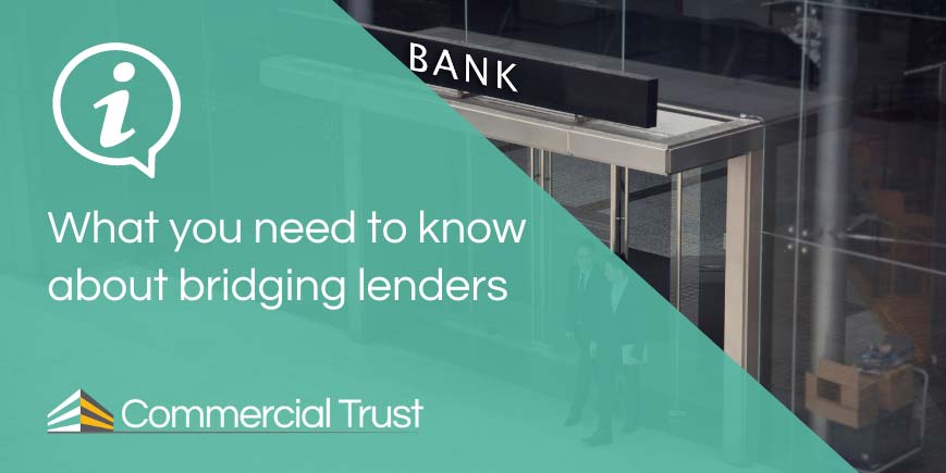 What you need to know about bridging lenders banner in front of front entrance to a glass-walled bank 