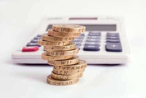 Coin stack next to calculator
