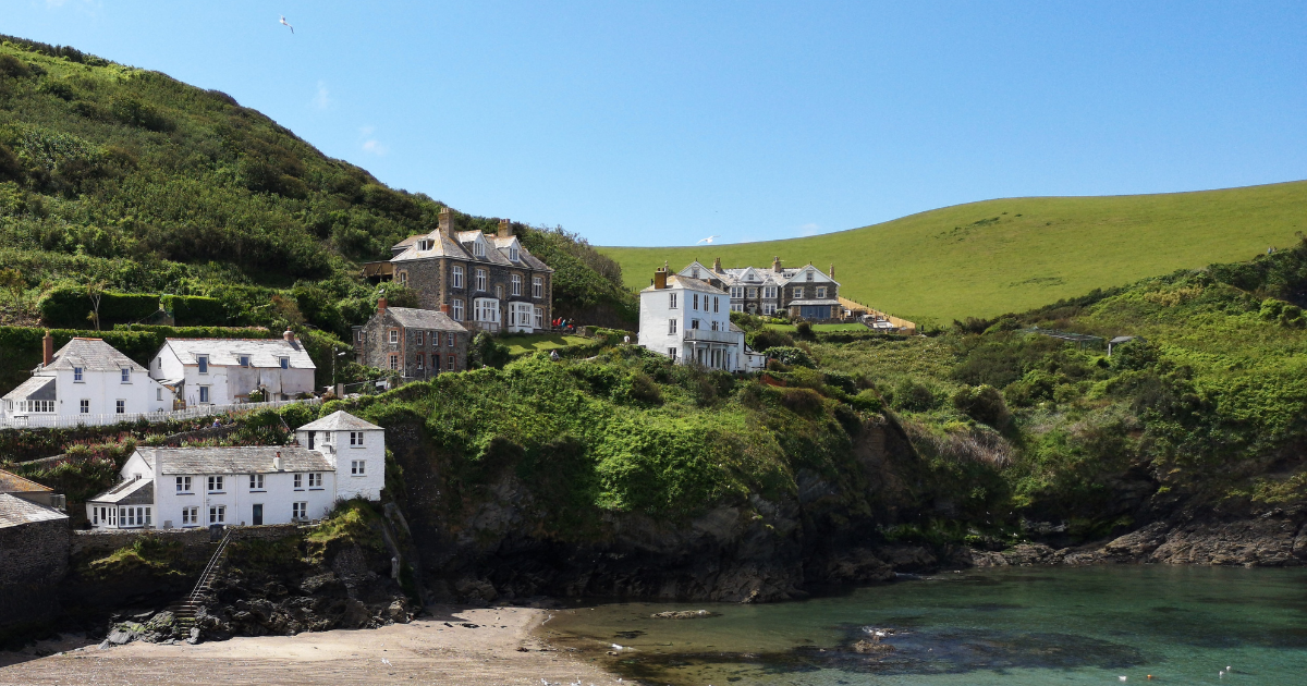Houses on the side of a hill overlooking a beach on a bright, sunny day