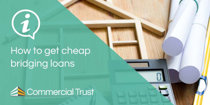 How to get cheap bridging loans banner in front of desk with a pen, notepad, calculator, a model of a house, and papers