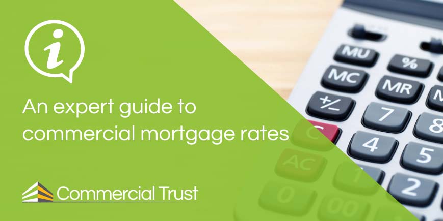 An expert guide to commercial mortgage rates banner in front of a calculator on a desk