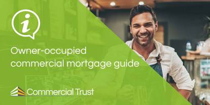 Owner occupied commercial mortgage green banner in front of business owner stood in their café