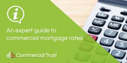 An expert guide to commercial mortgage rates banner in front of a calculator on a desk